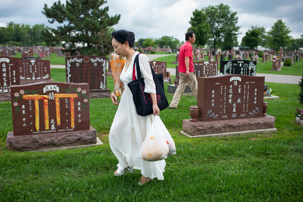 Sheng Xue and her husband, Xin Dong, visiting the graveyard where her parents are buried in Mississauga, Ontario.